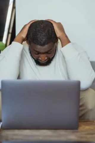 man-fatigued-in-front-of-a-laptop.webp